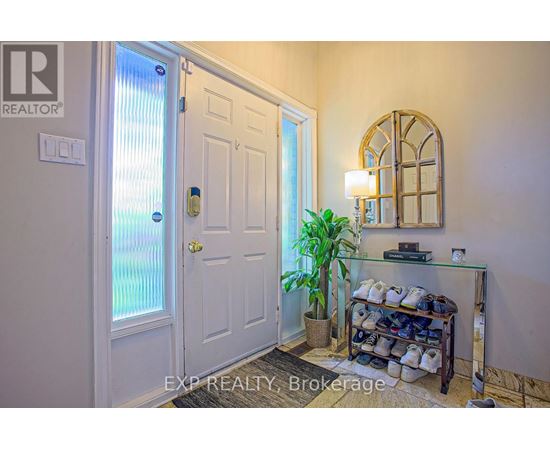 A white door with a glass window and a plant in front of it.