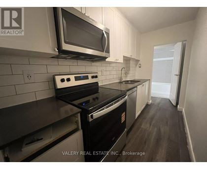 A kitchen with a stove top oven and microwave above it.