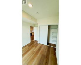 A room with wood flooring and white walls.