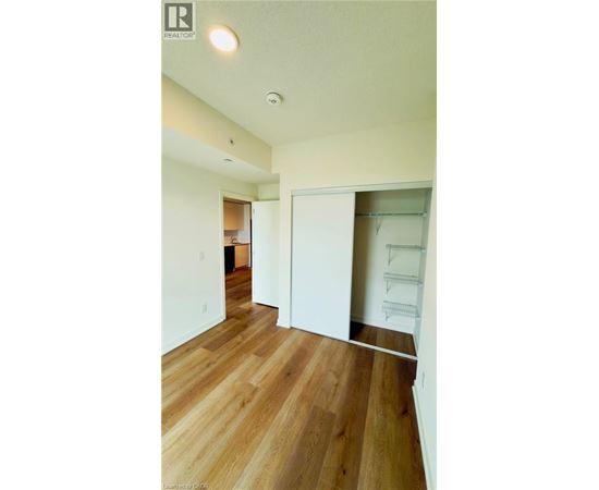 A room with wood flooring and white walls.