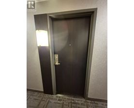 A dark brown door with a silver handle and a silver lock.