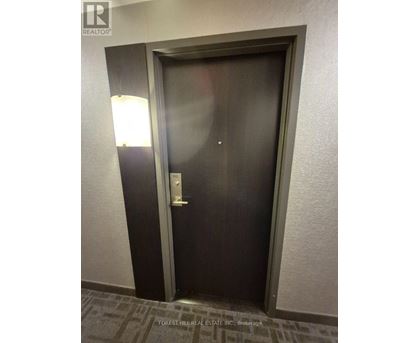 A dark brown door with a silver handle and a silver lock.