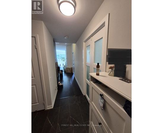 A hallway with a white door and a black floor.