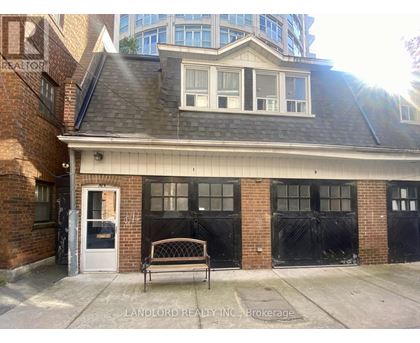 A brick building with a black door and windows.