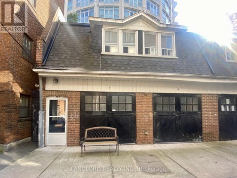 A brick building with a black door and windows.