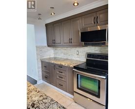 A kitchen with a black oven and microwave.