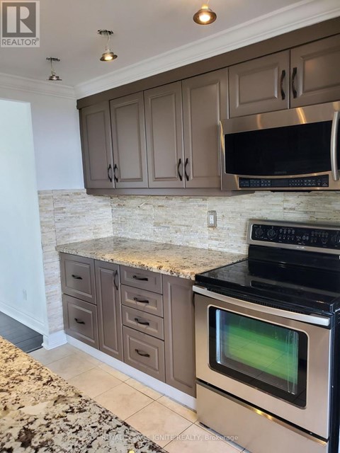 A kitchen with a black oven and microwave.