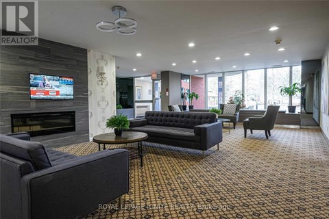 A living room with a fireplace and a television on the wall.