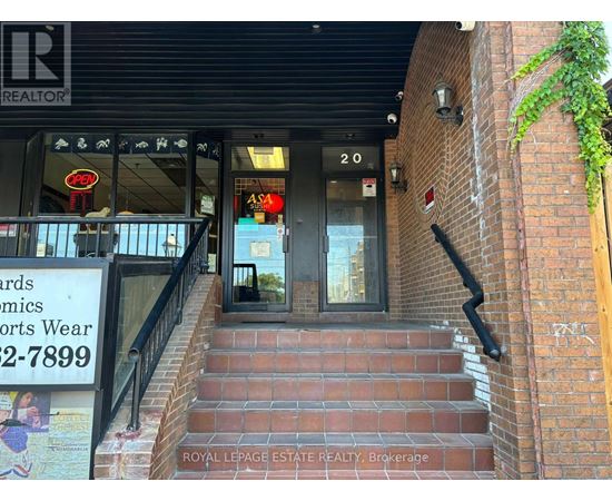 A building with a sign that says "Royal LePage Estate Realty, Brokerage" on the stairs.