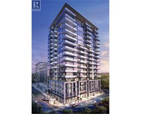 A modern multi-story residential building with balconies and a clear sky in the background.