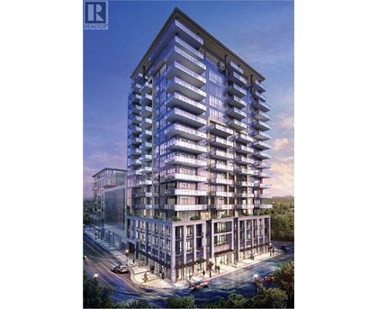 A modern multi-story residential building with balconies and a clear sky in the background.