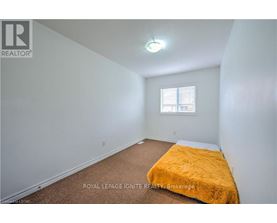 A bedroom with a bed covered in a yellow blanket.