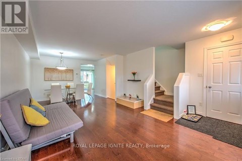 A living room with a grey couch and a yellow pillow.