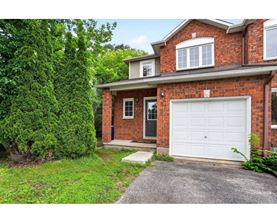 A red brick house with a white garage door.