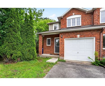 A red brick house with a white garage door.
