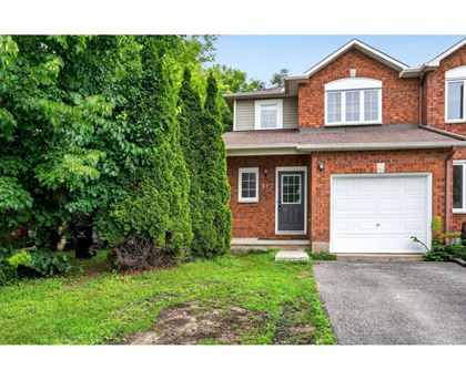 A house with a white garage door and a brick exterior.