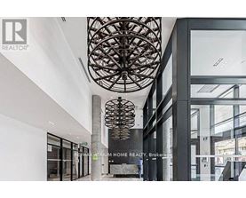 A modern interior space with a large, intricate chandelier hanging from the ceiling.
