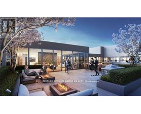 A modern building with people walking around and sitting on the patio.