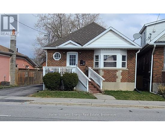 A house with a white front porch and a brick exterior.