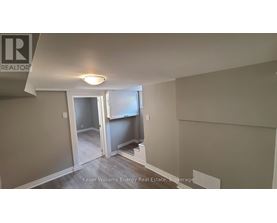 A room with a doorway leading to another room.