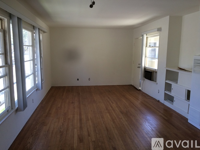 A room with wooden floors and white walls.