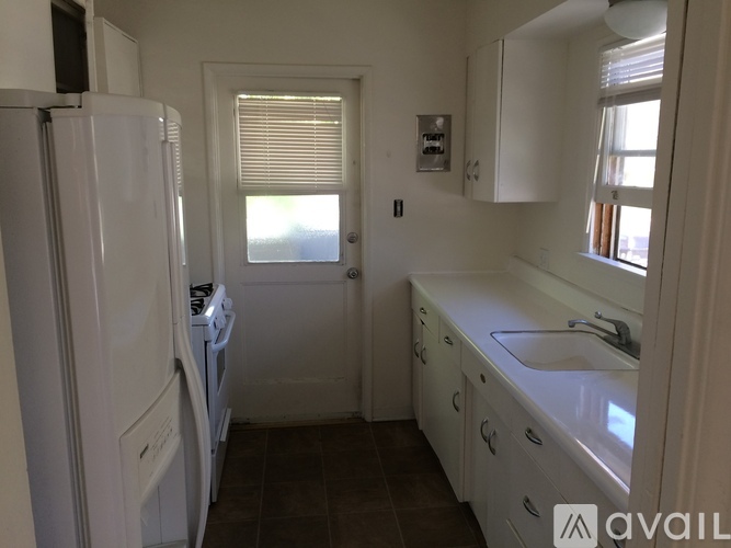 A small kitchen with white appliances and cabinets.