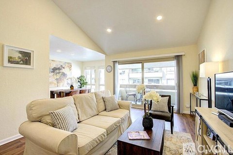 A living room with a beige couch and a coffee table.