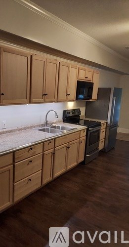 A kitchen with wooden cabinets and a stove top oven.