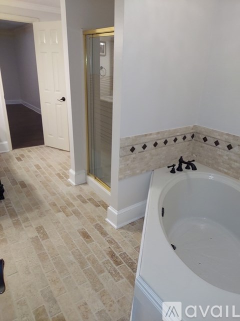 A bathroom with a tub and a walk-in shower.