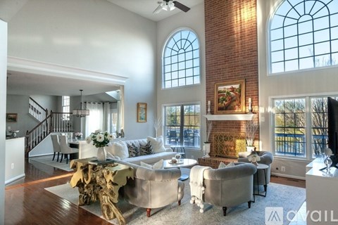A living room with a white couch and a wooden coffee table.