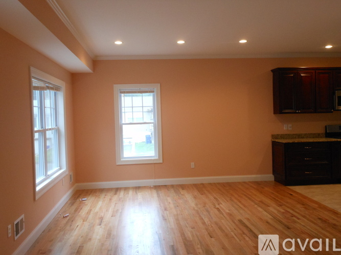 A room with wooden floors and a window.