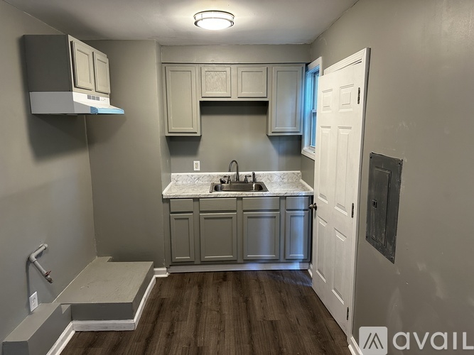 A kitchen with a sink and a window.