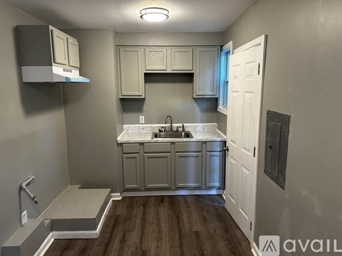A kitchen with a sink and a window.