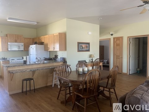 A kitchen with a table and chairs in the middle of the room.