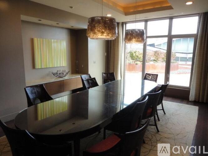 A dining room with a glass table and chairs.