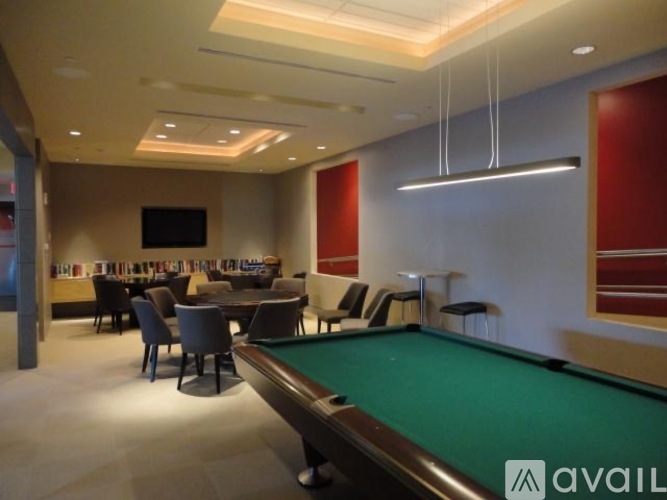 A room with a pool table and a television.