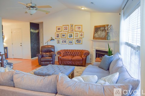 A living room with a grey couch and a brown leather chair.