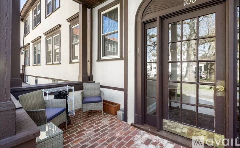 A patio with a table and chairs outside a building.