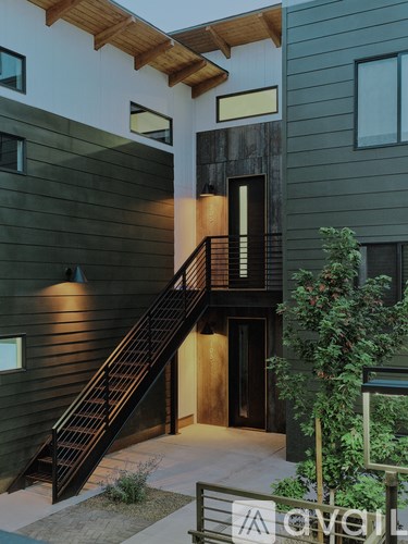 A modern house with a wooden staircase leading to the second floor.