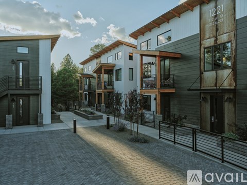 A row of modern houses with balconies and doors are shown in the image.