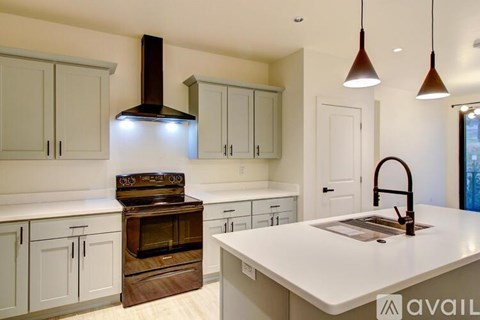 A kitchen with a white countertop and a wood stove.