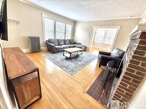 A living room with a grey sofa and a wooden coffee table.