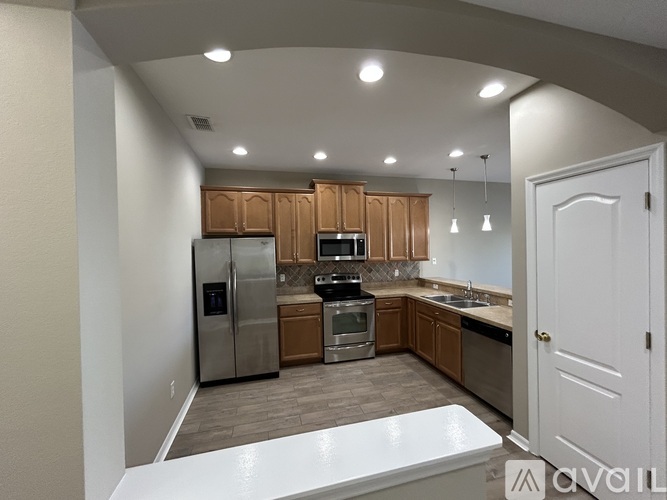 A kitchen with wooden cabinets and stainless steel appliances.