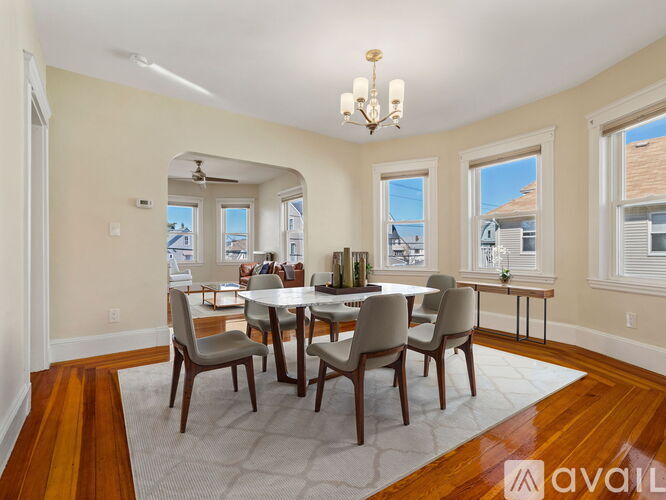 A dining room with a table set for six.