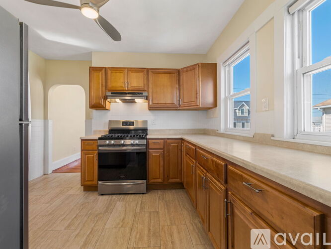 A kitchen with wooden cabinets and a black oven.