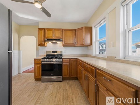 A kitchen with wooden cabinets and a black oven.