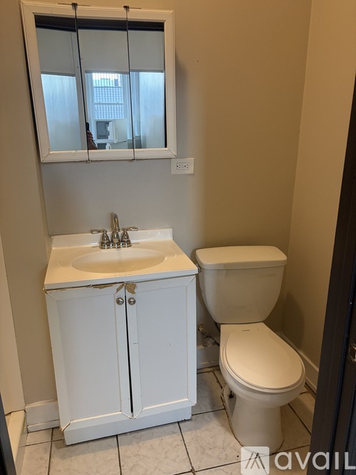 A white sink and toilet in a bathroom.