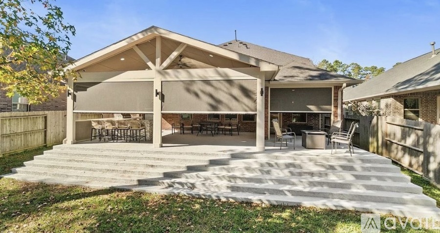 A house with a covered patio and a stone walkway leading to it.