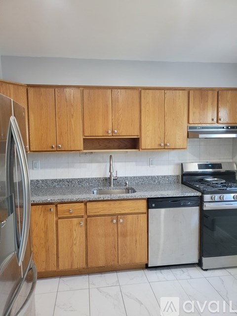 A kitchen with wooden cabinets and stainless steel appliances.