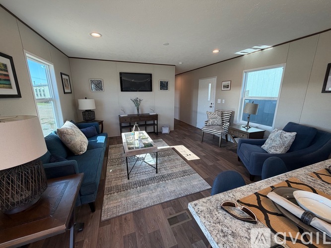 A living room with a blue couch and a coffee table.